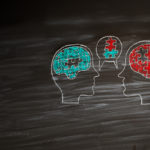 Two illustrated heads with speech bubbles connecting, each with puzzle pieces fitting together, symbolizing problem-solving coaching.