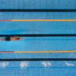 Individual swimming in an aesthetically arranged pool, symbolizing metric-based process mapping.
