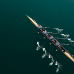 Individuals in a single canoe rowing in unison, symbolizing a rapid improvement event.